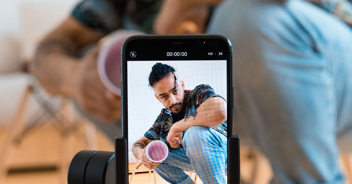A creator recording a video with a phone on a tripod