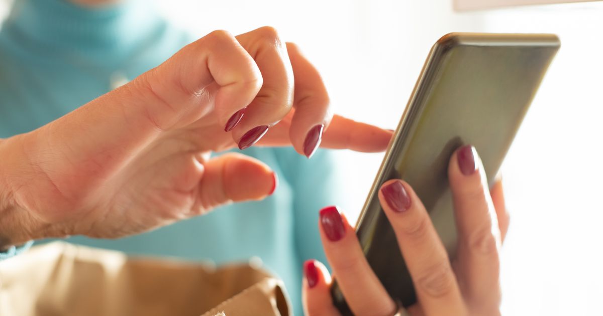 Hands interacting with a smartphone screen