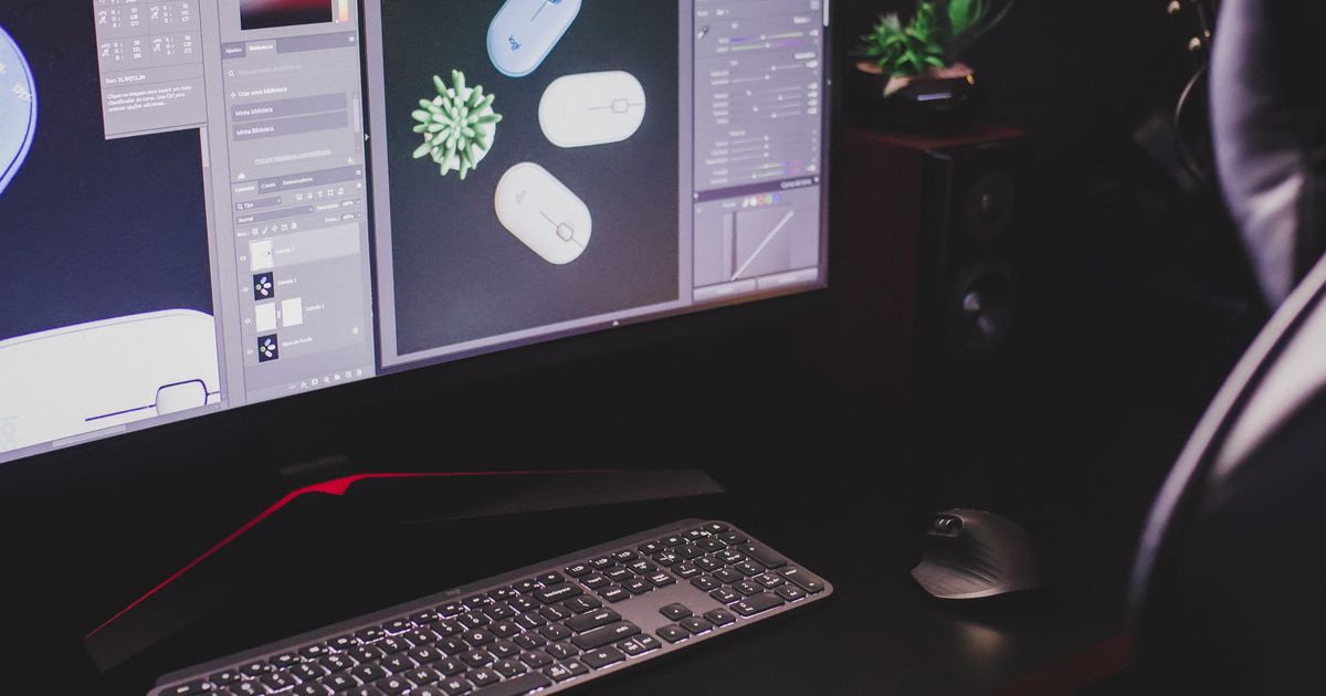 A dual-monitor computer setup with keyboard and mouse