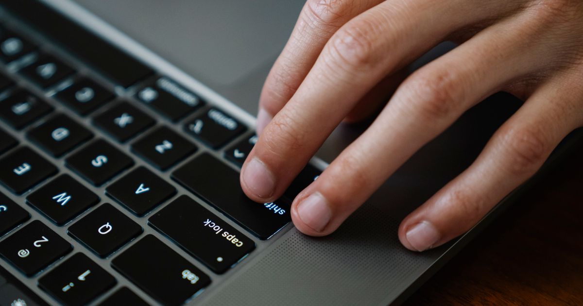 Tangan menggunakan keyboard laptop saat bekerja